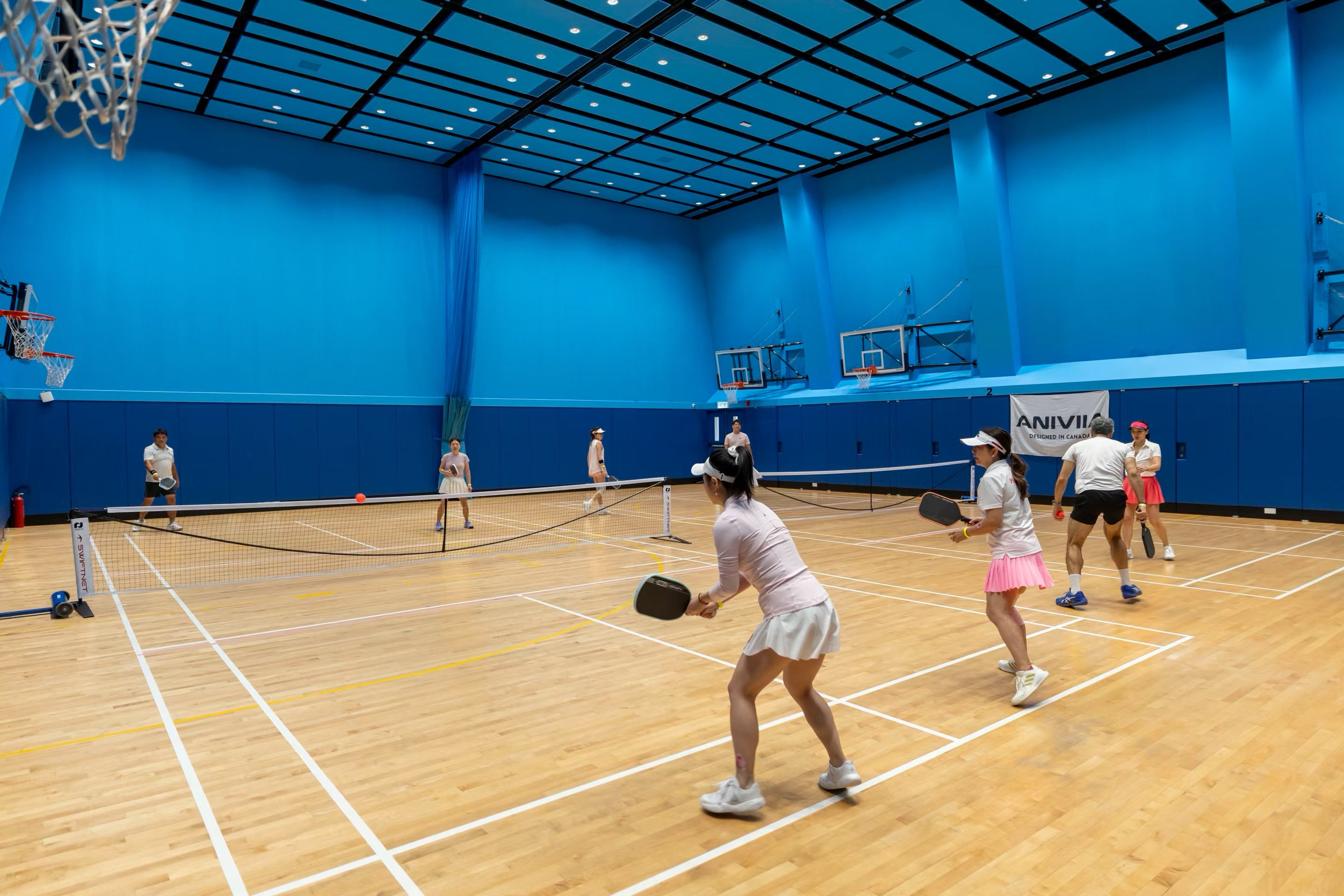 Owner-provided event photograph of mixed doubles pickleball being played in the sports hall.
